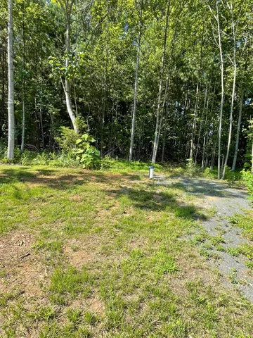 a backyard of a house with a table and chairs