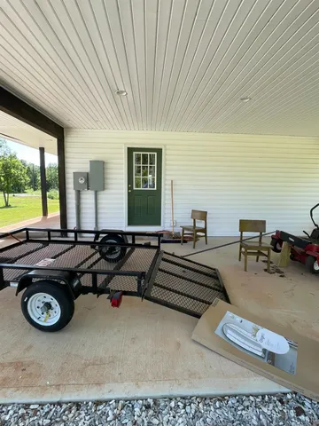a living room with furniture a rug and a large window