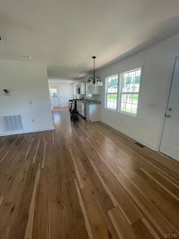 a view of a room with wooden floor and windows