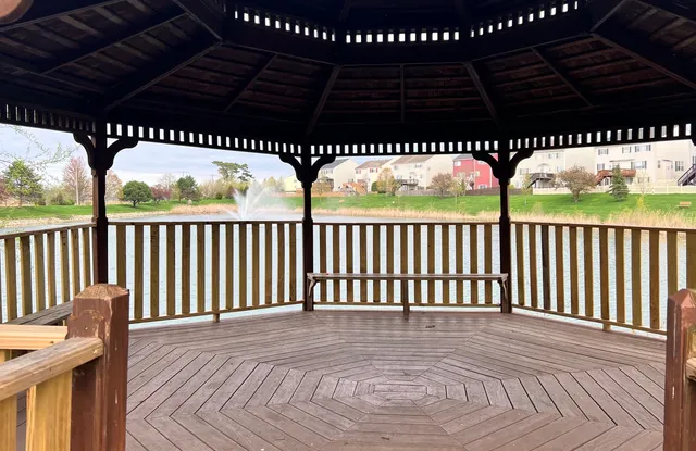 a view of an ocean with boats and trees in the background