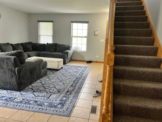 a living room with a couch and a rug