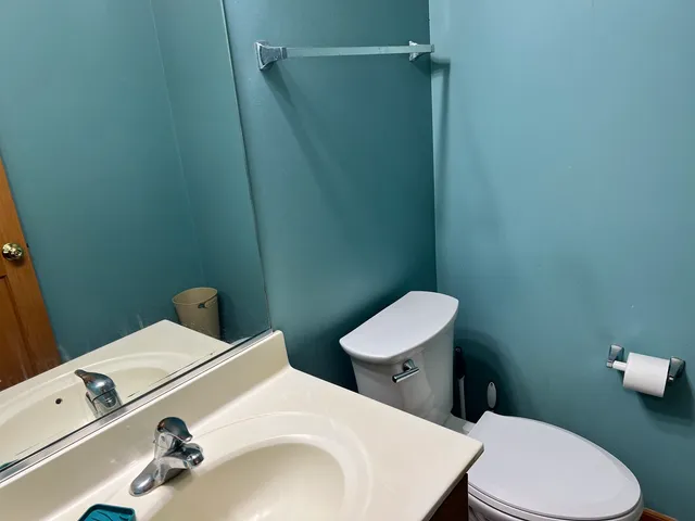a white toilet sitting next to a bathroom sink
