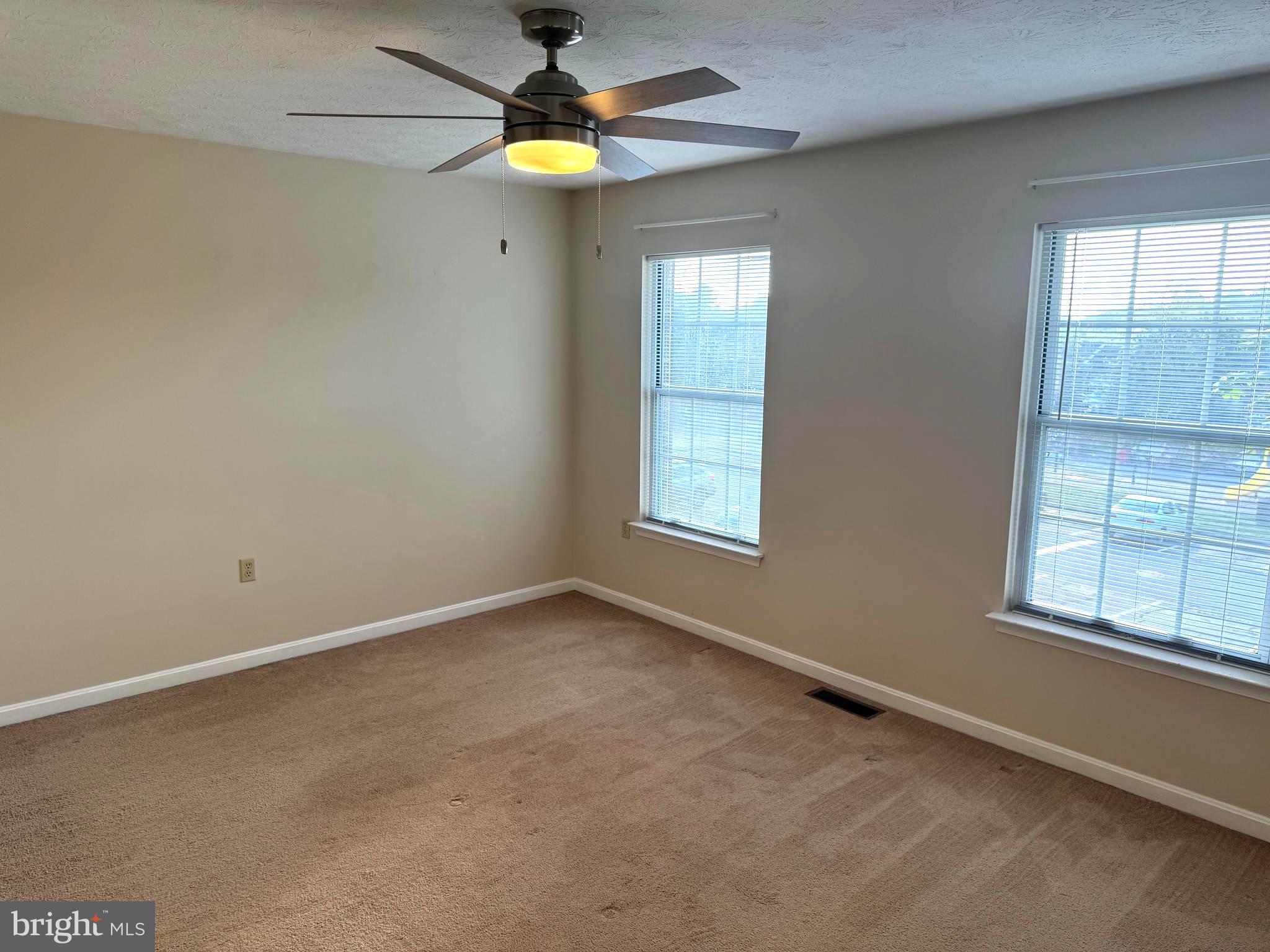 307 Willowbrook Court Winchester, VA 22602 - Photo 12 of 15 an empty room with windows and fan