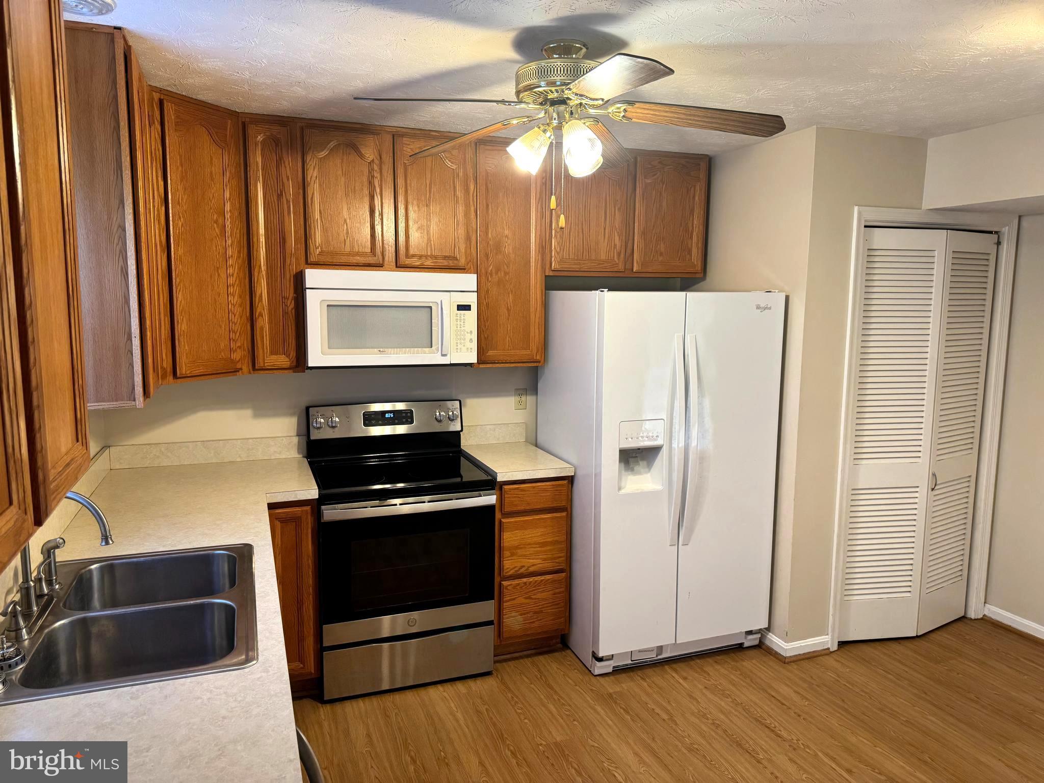 307 Willowbrook Court Winchester, VA 22602 - Photo 5 of 15 a kitchen with granite countertop wooden cabinets and stainless steel appliances