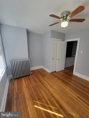 a view of a room with wooden floor and white walls