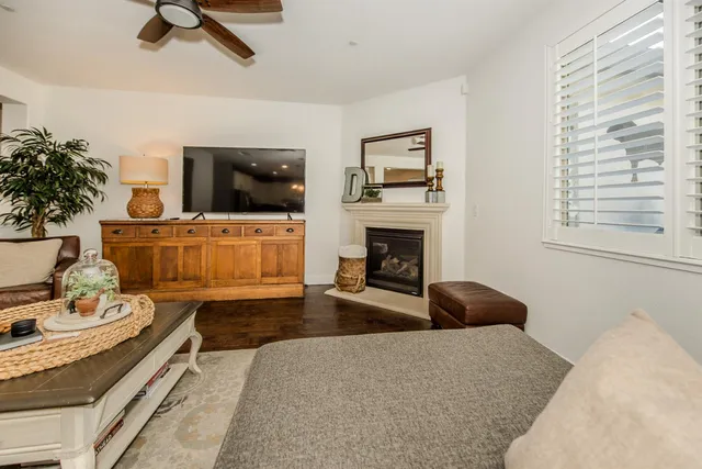 a bedroom with a bed a couch and a chandelier