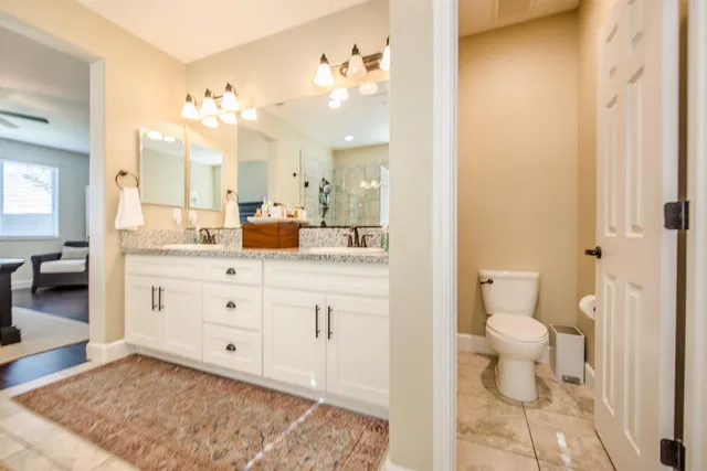 a bathroom with a granite countertop sink a mirror and a bathtub