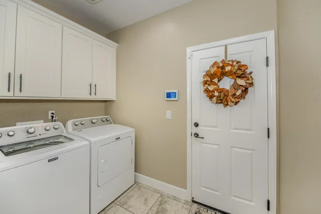 a backyard of a house with table and chairs