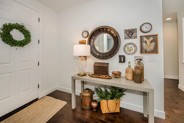 a very nice looking dining room with kitchen view and a large window