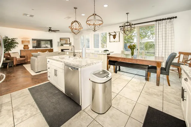 a kitchen with stainless steel appliances granite countertop a sink refrigerator and microwave