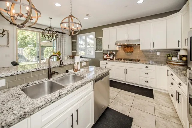 a kitchen with stainless steel appliances a refrigerator sink and cabinets