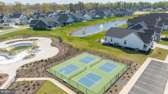 a view of a a dining room with furniture window and wooden floor