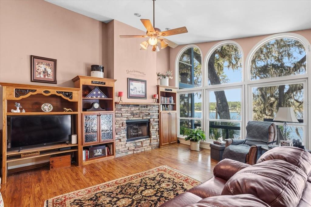 8386 Austin Road Melrose, FL 32666 - Photo 14 of 76 a living room with furniture a flat screen tv and a fireplace