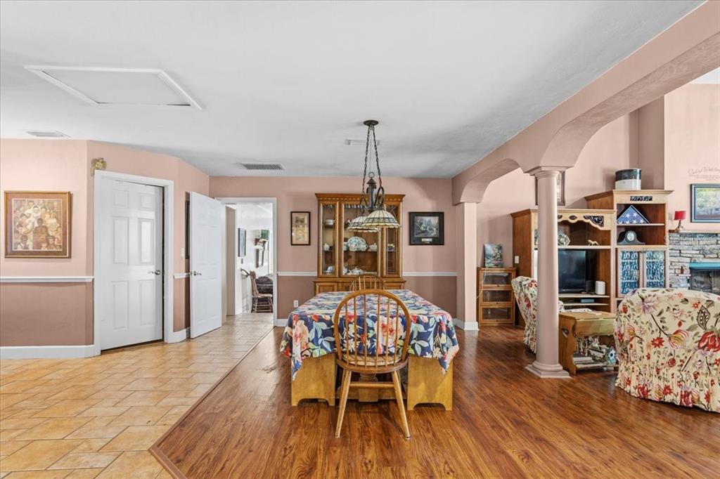 8386 Austin Road Melrose, FL 32666 - Photo 15 of 76 a view of a dining room with furniture and wooden floor