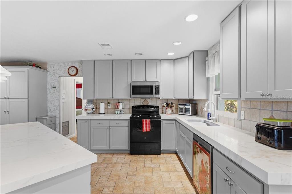 8386 Austin Road Melrose, FL 32666 - Photo 21 of 76 a kitchen with granite countertop stainless steel appliances and wooden cabinets