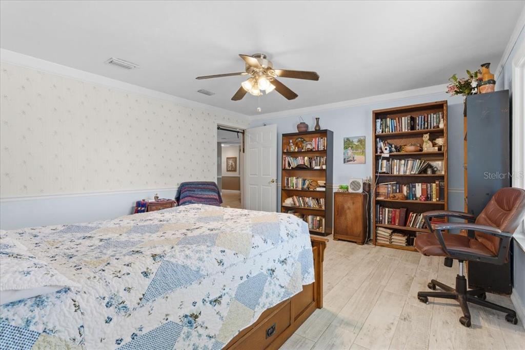 8386 Austin Road Melrose, FL 32666 - Photo 28 of 76 a bedroom with a bed a book shelf and a window