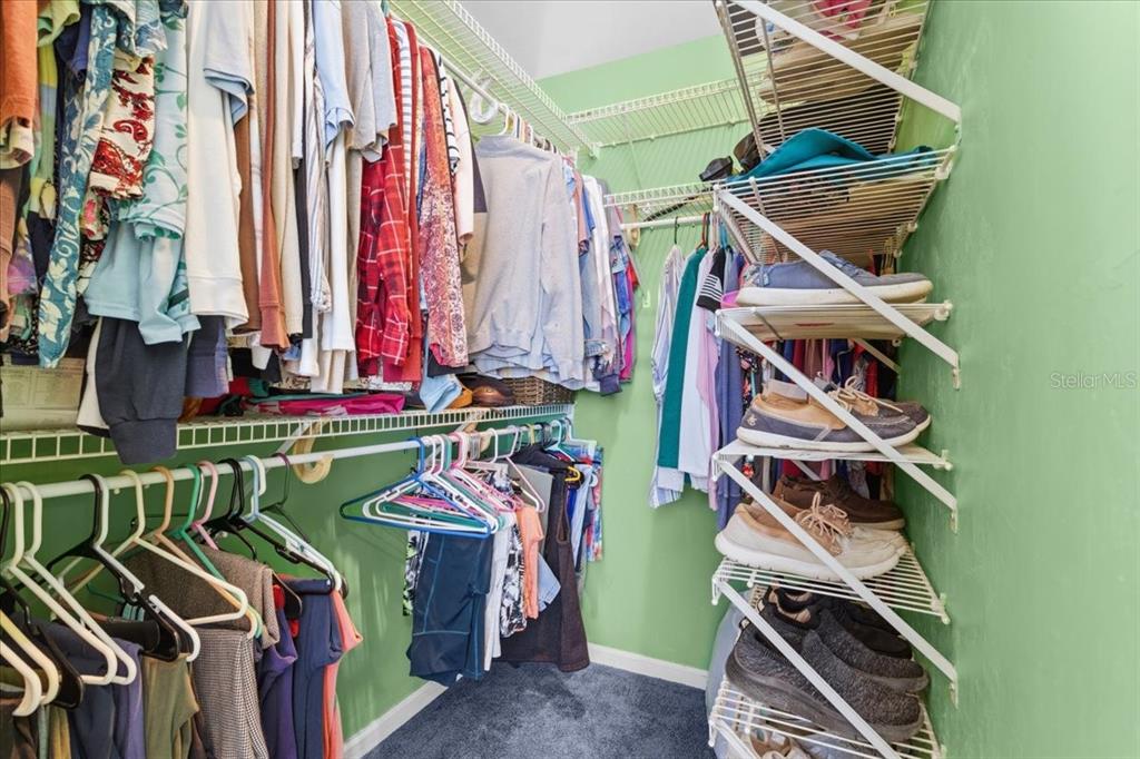 8386 Austin Road Melrose, FL 32666 - Photo 36 of 76 a view of walk in closet with clothes and shoes