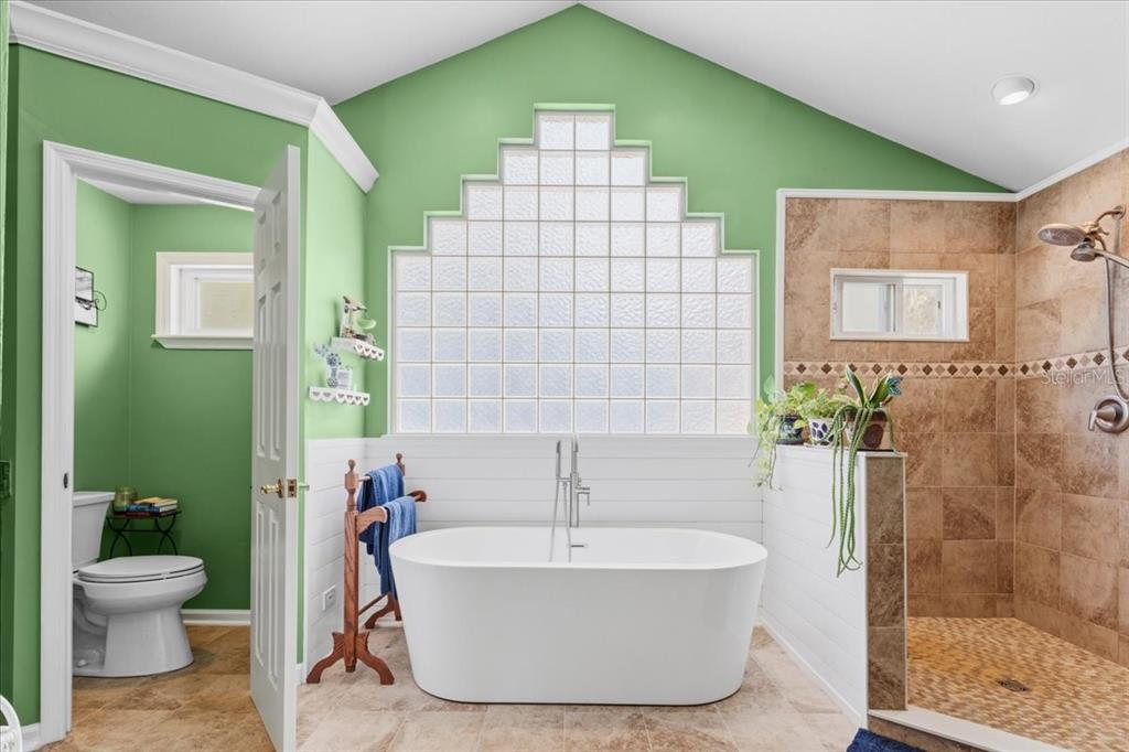 8386 Austin Road Melrose, FL 32666 - Photo 38 of 76 a bathroom with a white tub shower and a sink