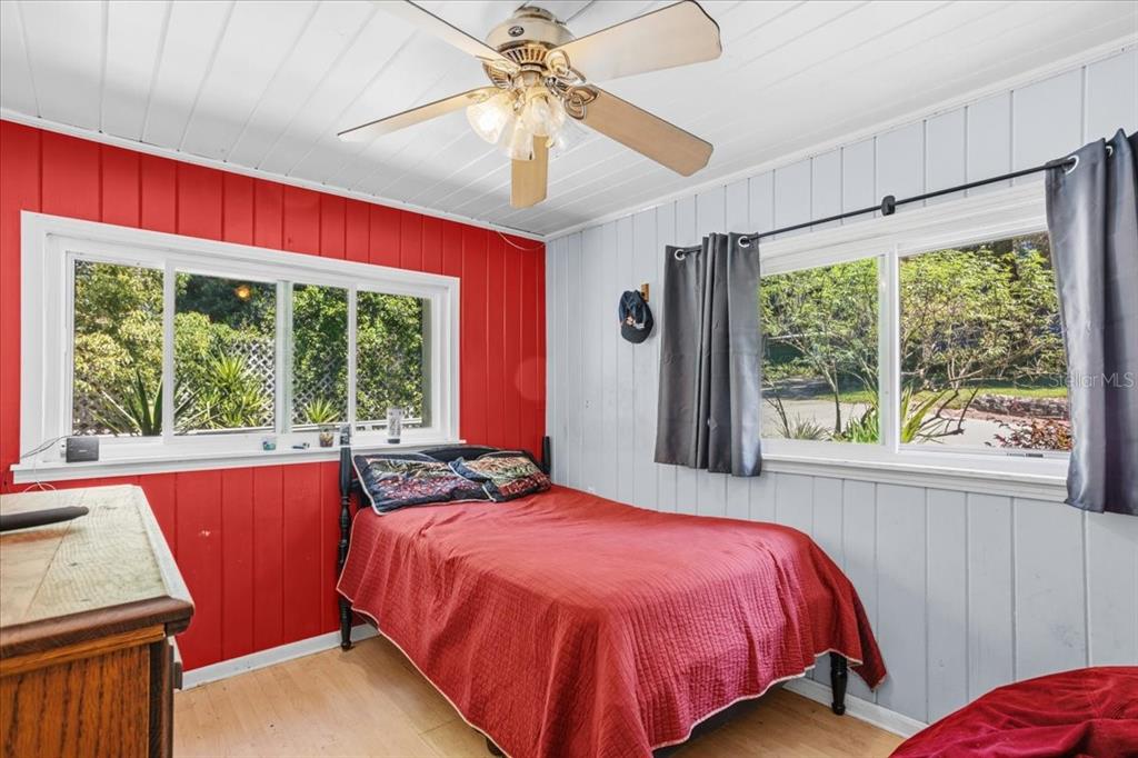 8386 Austin Road Melrose, FL 32666 - Photo 46 of 76 a bed sitting in a bedroom next to a window