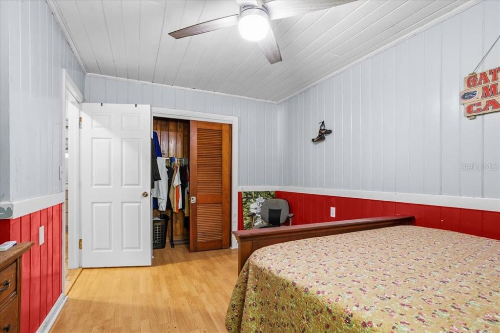 8386 Austin Road Melrose, FL 32666 - Photo 49 of 76 a bedroom with a bed and a chandelier