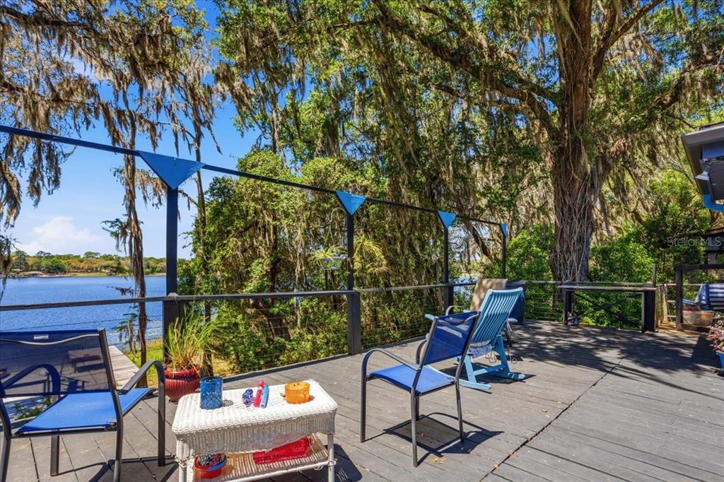 8386 Austin Road Melrose, FL 32666 - Photo 51 of 76 a roof deck with table and chairs and potted plants