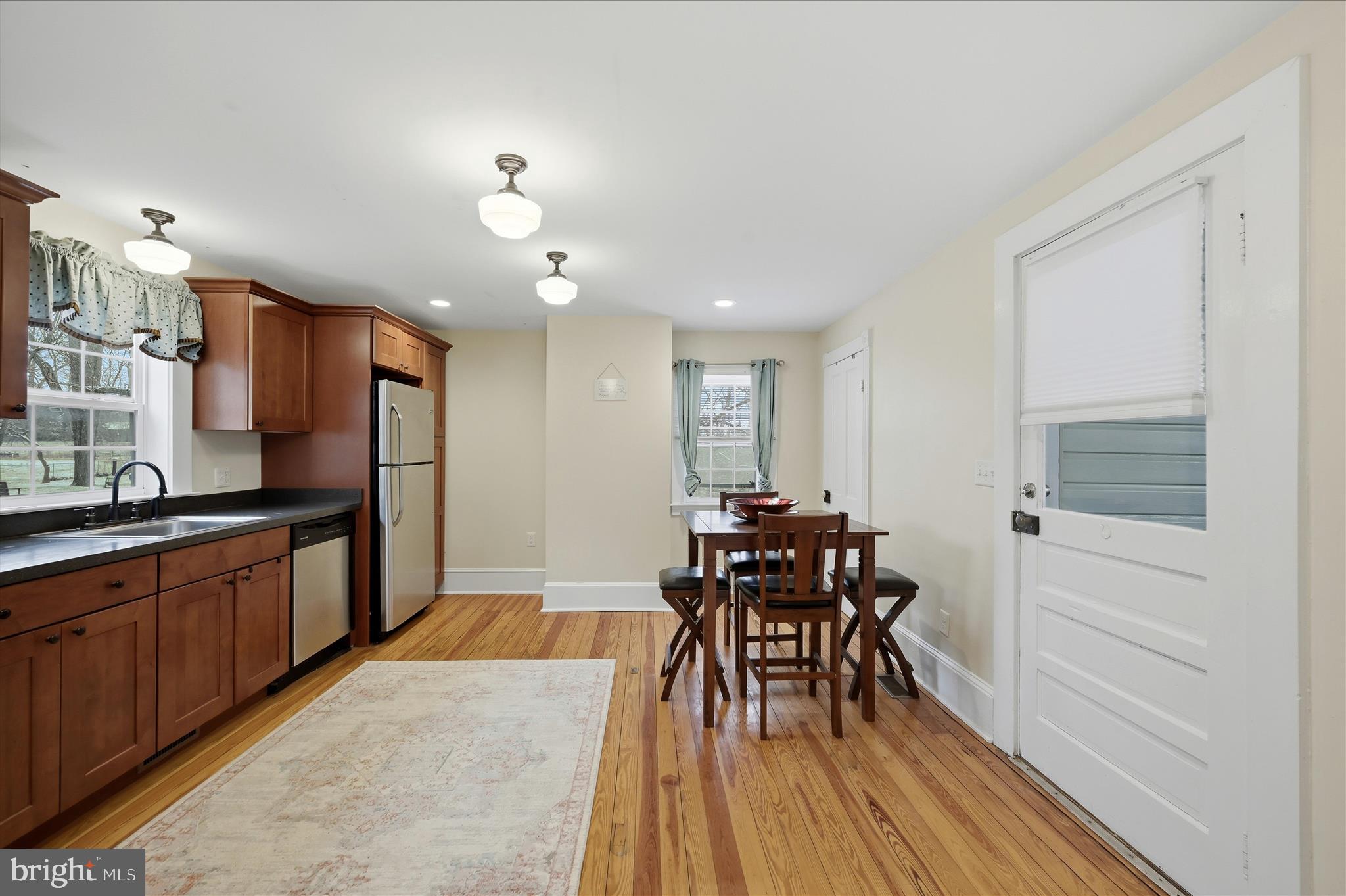 2 West Main Street Boyce, VA 22620 - Photo 21 of 65 a kitchen with stainless steel appliances kitchen island granite countertop a table chairs and a wooden floors