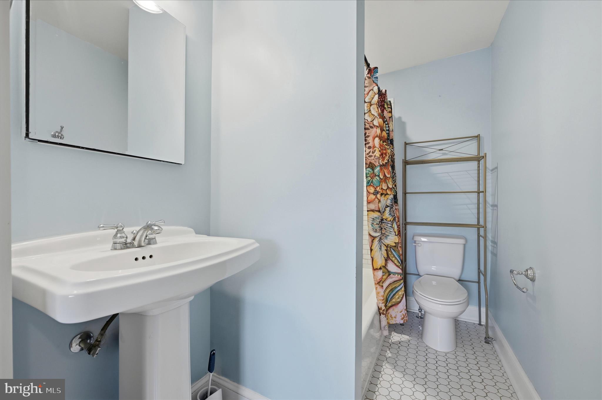 2 West Main Street Boyce, VA 22620 - Photo 47 of 65 a bathroom with a sink a toilet and shower curtain