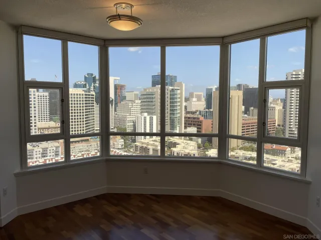a bathroom with a granite countertop sink a toilet and a mirror
