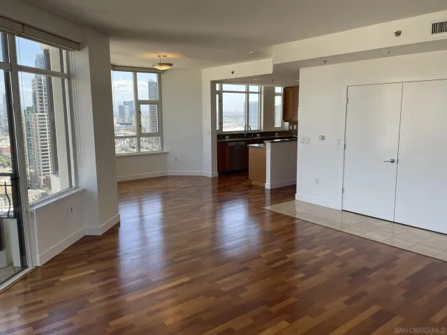 a bathroom with a granite countertop sink a toilet and a mirror