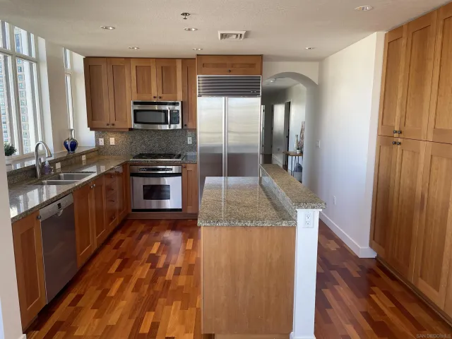 a living room with furniture fireplace and a large window