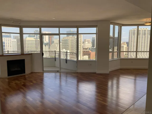 a view of a hallway with furniture and wooden floor