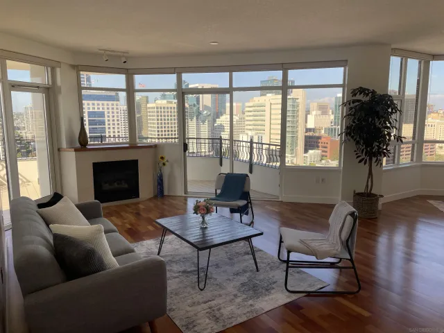 a bedroom with furniture and a large window