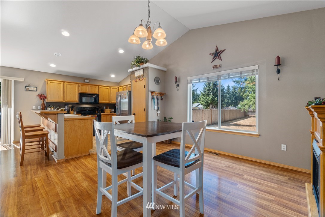 5037 180th Trail Southwest Rochester, WA 98579 - Photo 11 of 38 a view of a dining room with furniture window and wooden floor