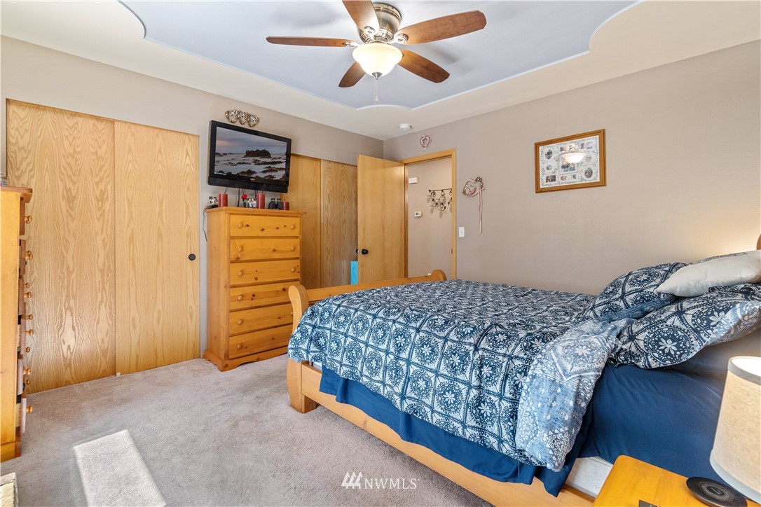 5037 180th Trail Southwest Rochester, WA 98579 - Photo 13 of 38 a bedroom with a bed and a ceiling fan
