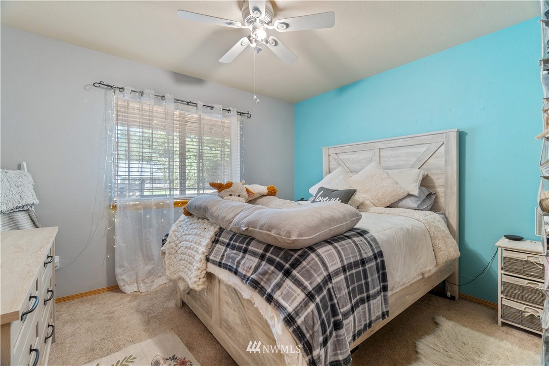 5037 180th Trail Southwest Rochester, WA 98579 - Photo 15 of 38 a bedroom with a bed and a window