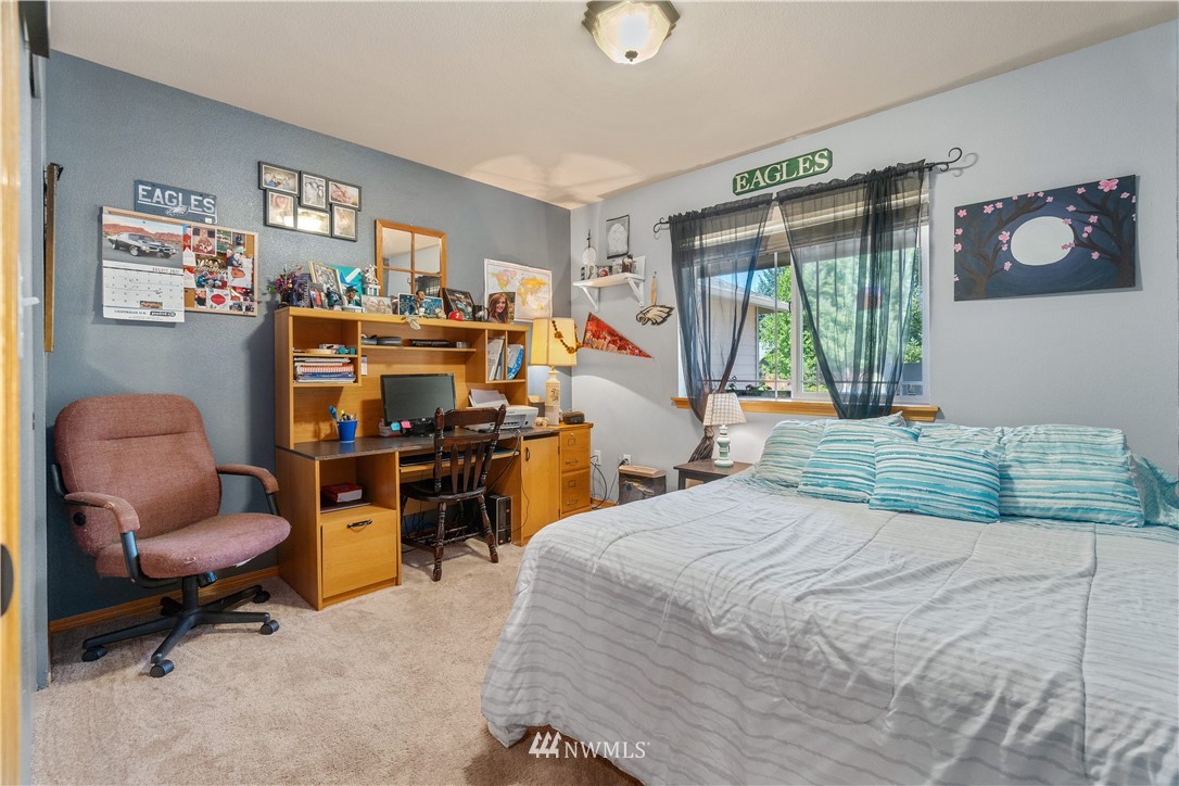 5037 180th Trail Southwest Rochester, WA 98579 - Photo 16 of 38 a bed room with a bed and a chair