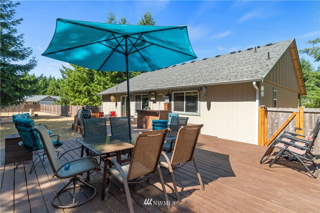 5037 180th Trail Southwest Rochester, WA 98579 - Photo 21 of 38 a view of a table and chairs under an umbrella