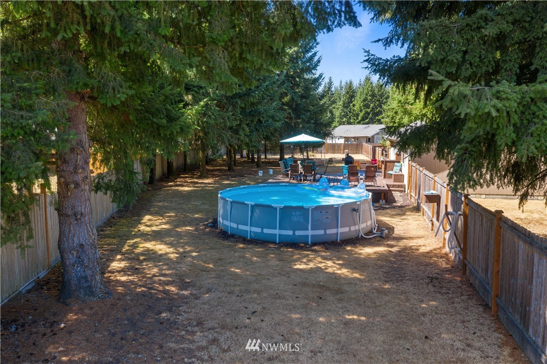 5037 180th Trail Southwest Rochester, WA 98579 - Photo 25 of 38 a view of a backyard with large trees and plants