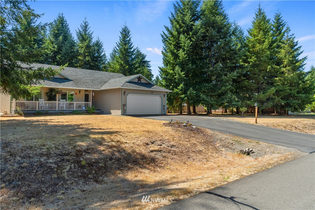 5037 180th Trail Southwest Rochester, WA 98579 - Photo 28 of 38 a front view of a house with a yard