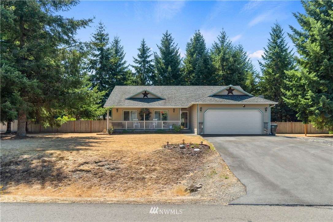 5037 180th Trail Southwest Rochester, WA 98579 - Photo 31 of 38 a front view of a house with a yard and trees