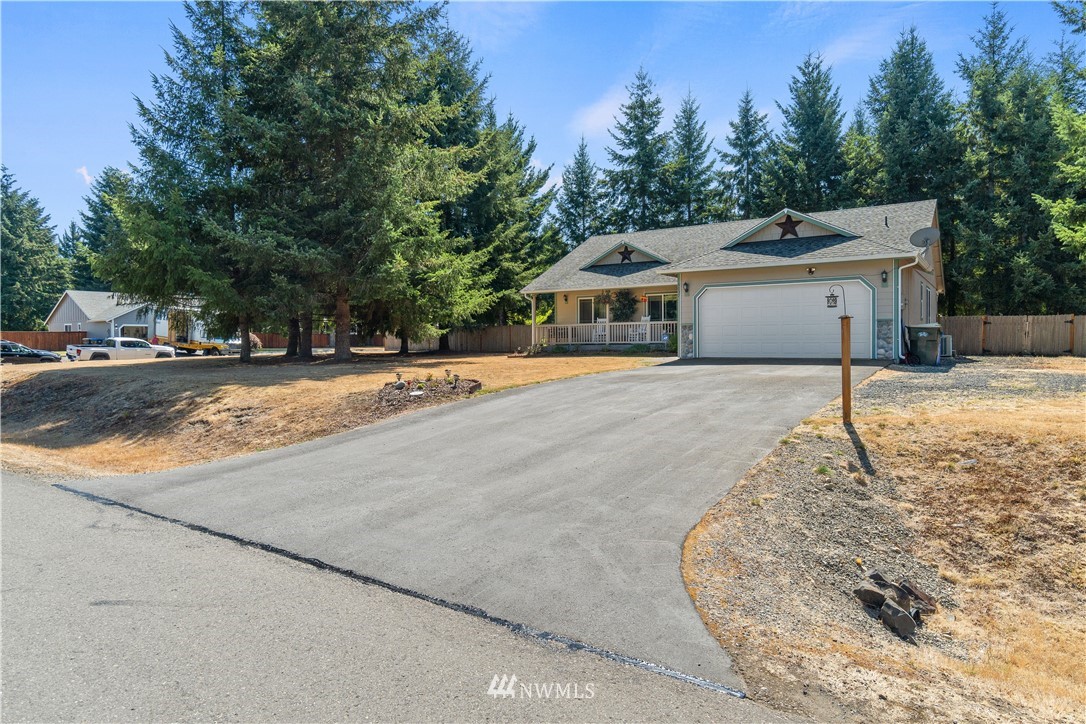 5037 180th Trail Southwest Rochester, WA 98579 - Photo 32 of 38 a view of a house with a yard