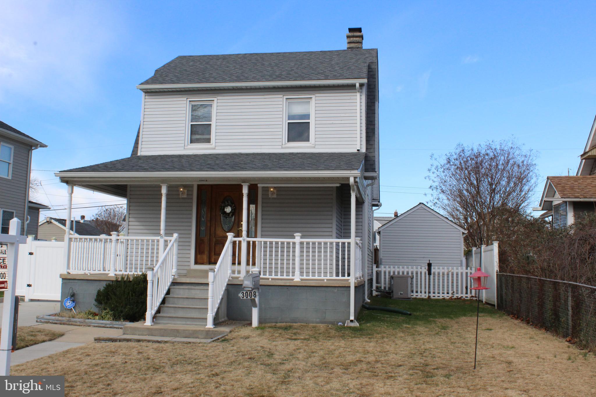 3008 Ritchie Avenue Baltimore, MD 21219 - Photo 3 of 34 a front view of a house with a yard