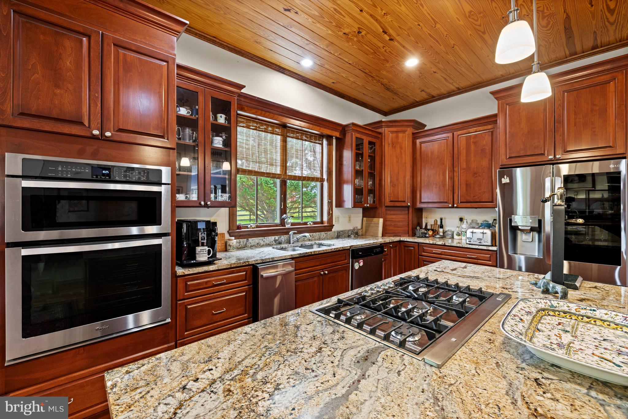 20147 Woodtrail Road Round Hill, VA 20141 - Photo 17 of 41 a kitchen with stainless steel appliances granite countertop a stove sink and cabinets