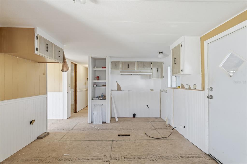 4403 Tucker Square New Port Richey, FL 34652 - Photo 2 of 20 a view of a kitchen with a refrigerator and cabinets