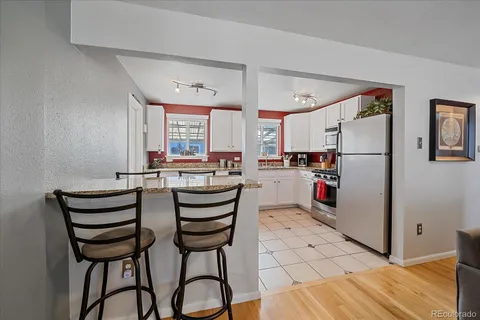 a kitchen with a refrigerator and table chair