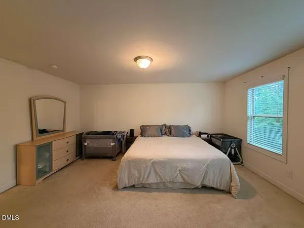 a bedroom with a bed and a tv