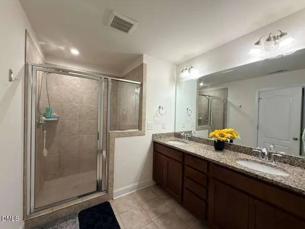 a bathroom with double sink and a mirror