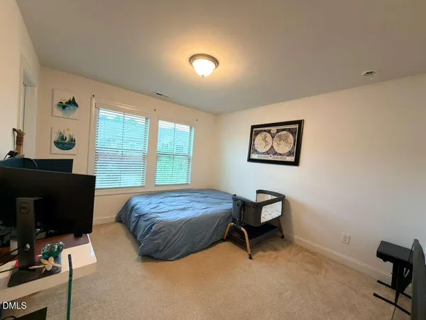 a bedroom with a bed and a desk