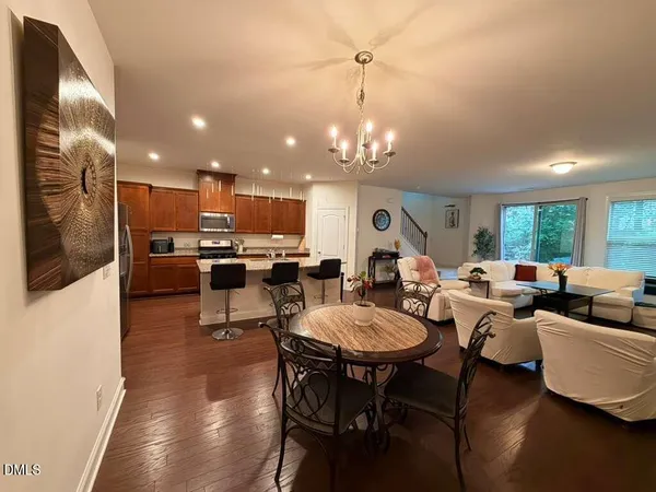a living room with lots of furniture and kitchen view