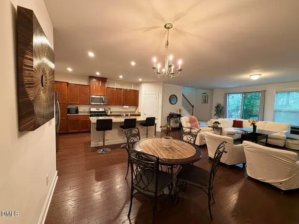 a living room with lots of furniture and kitchen view